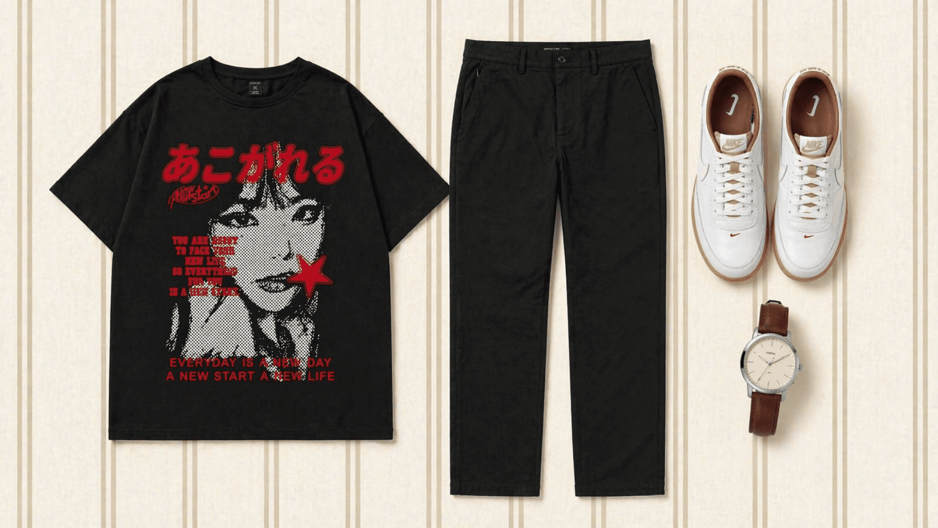 Flat lay of black graphic tee, straight black chinos, white sneakers, and watch on a clean beige striped background.