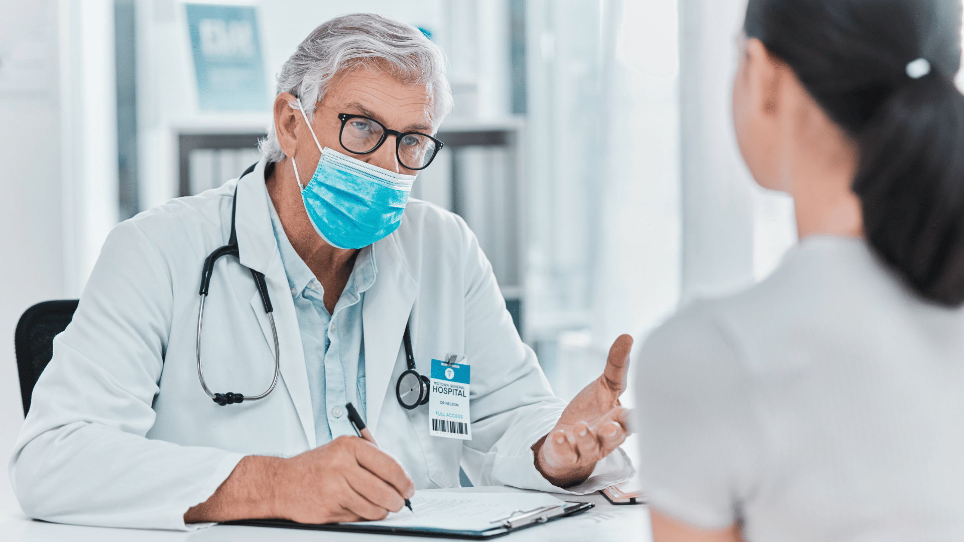 doctor consulting patient during health checkup in clinic.