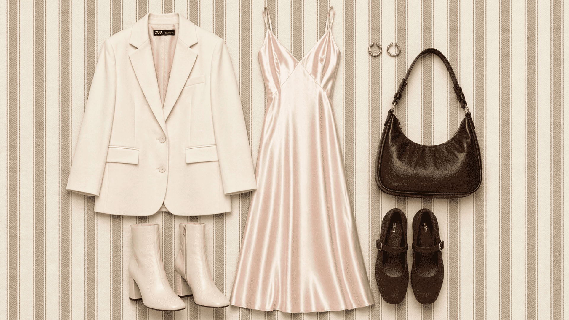 Flat lay outfit with cream blazer, blush satin dress, boots, brown bag and flats on beige background with subtle brown vertical stripes