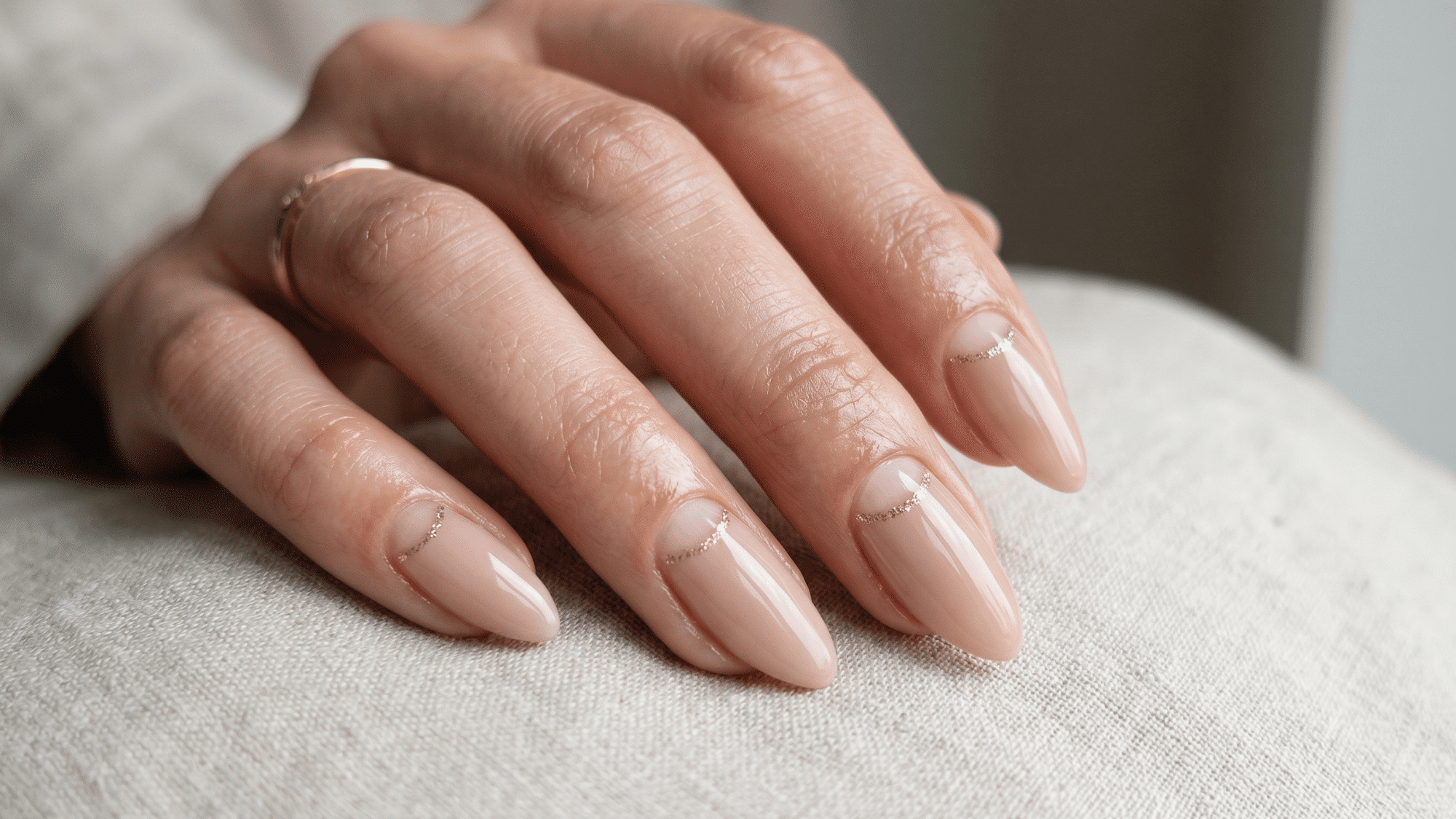 nude half moon nails with minimal cuticle design and glossy finish