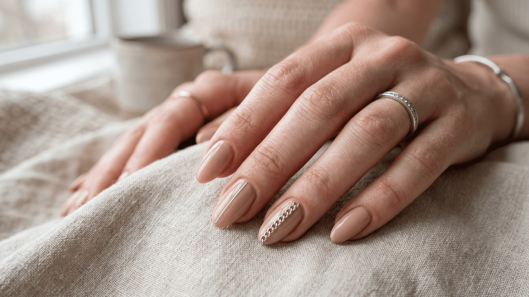 soft beige nails with nail chain art