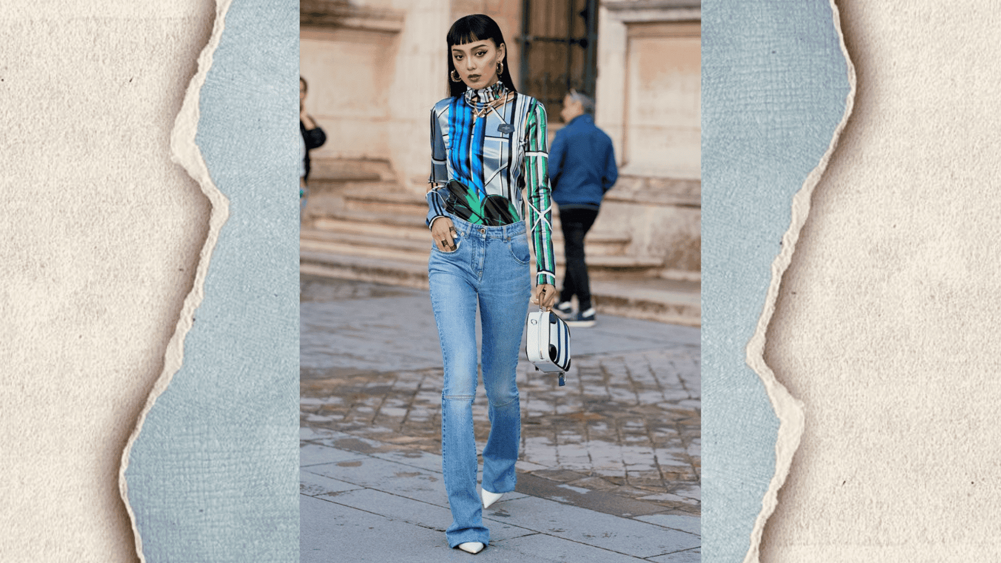 street style colourful printed top with light wash bootcut jeans, white pointed heels and mini bag