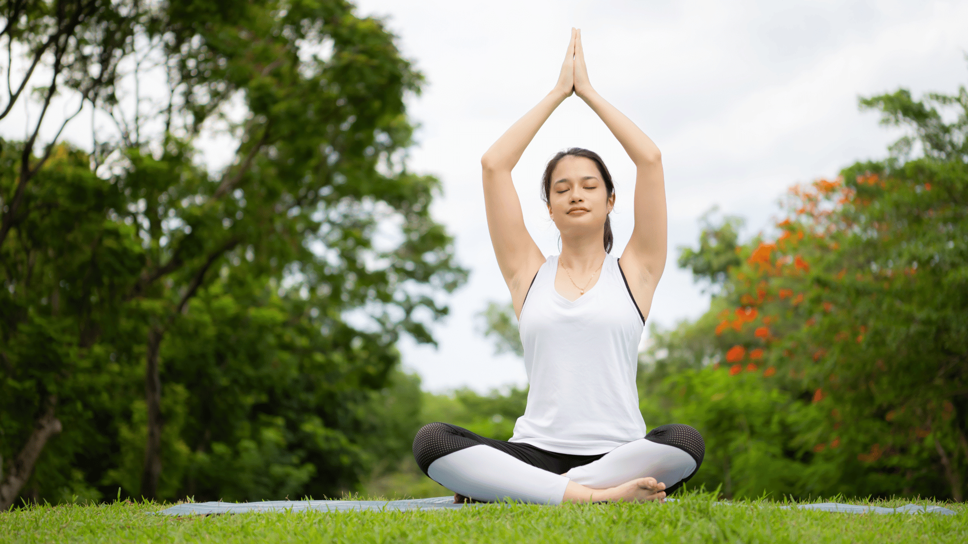 woman doing yoga outdoors showing fitness and mental balance.