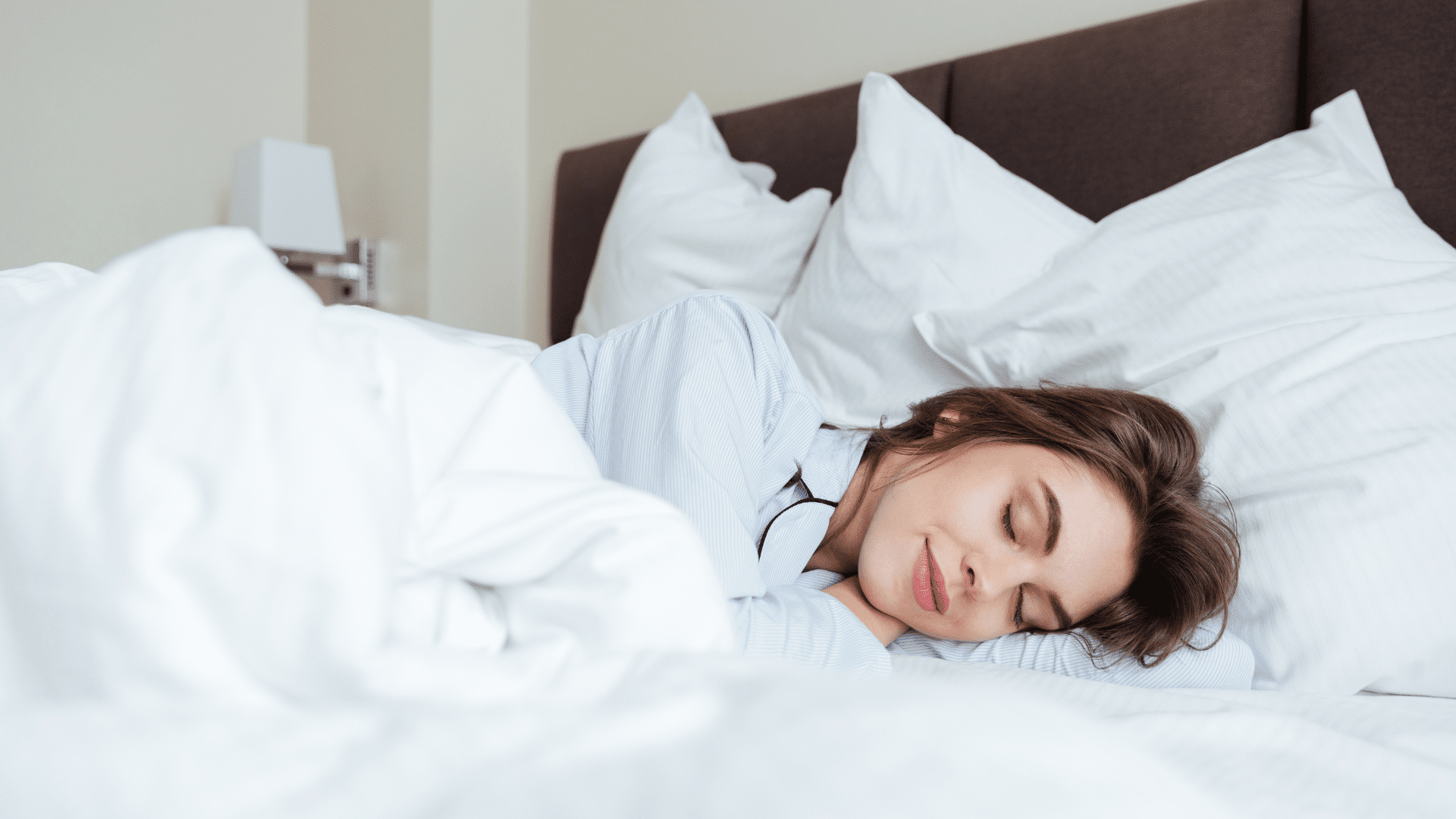 woman sleeping peacefully in bed showing healthy sleep habits.