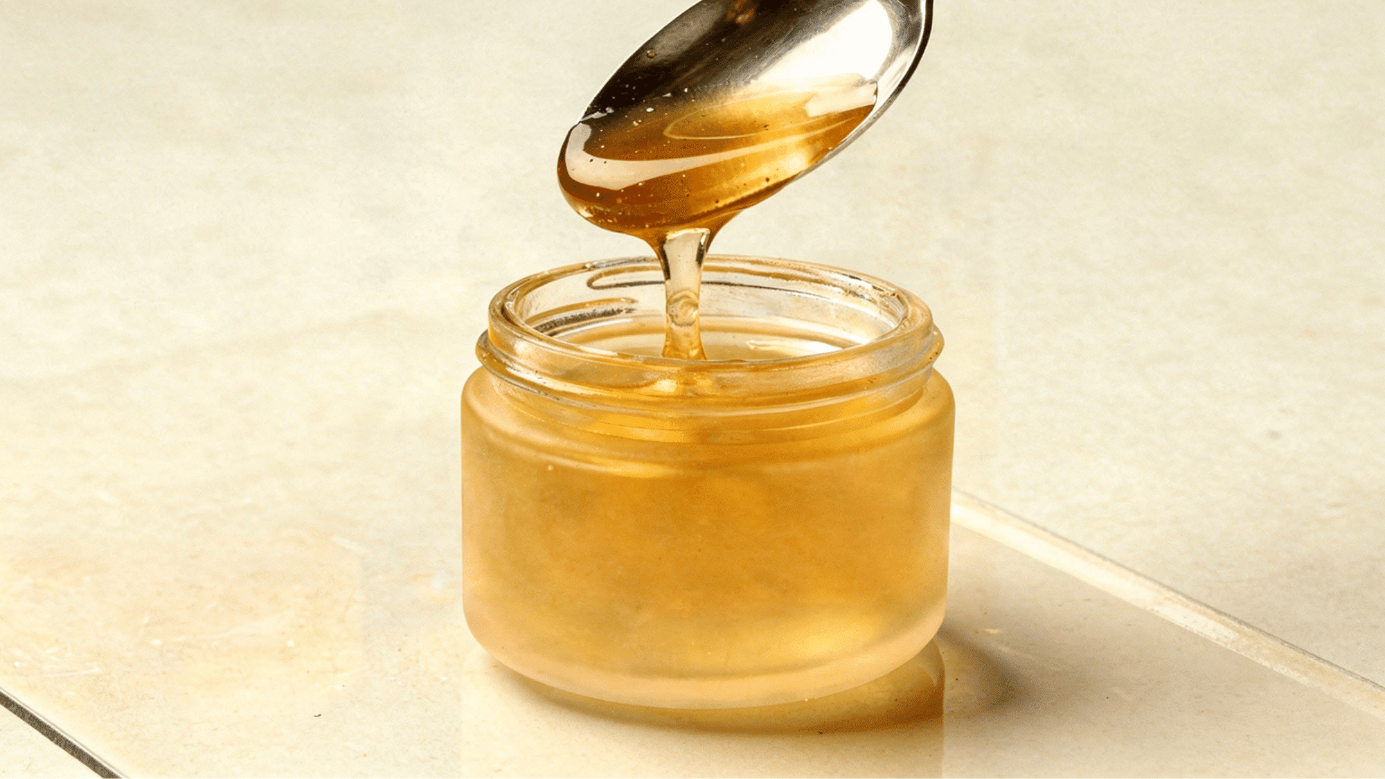 Raw honey and water mixed together in glass jar