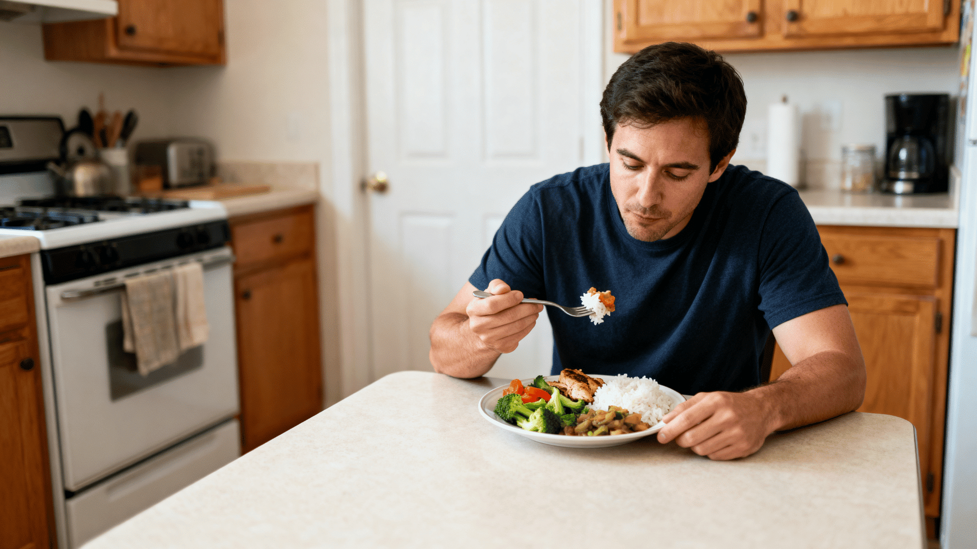 man eating a balanced meal with vegetables, protein, and whole grains at home