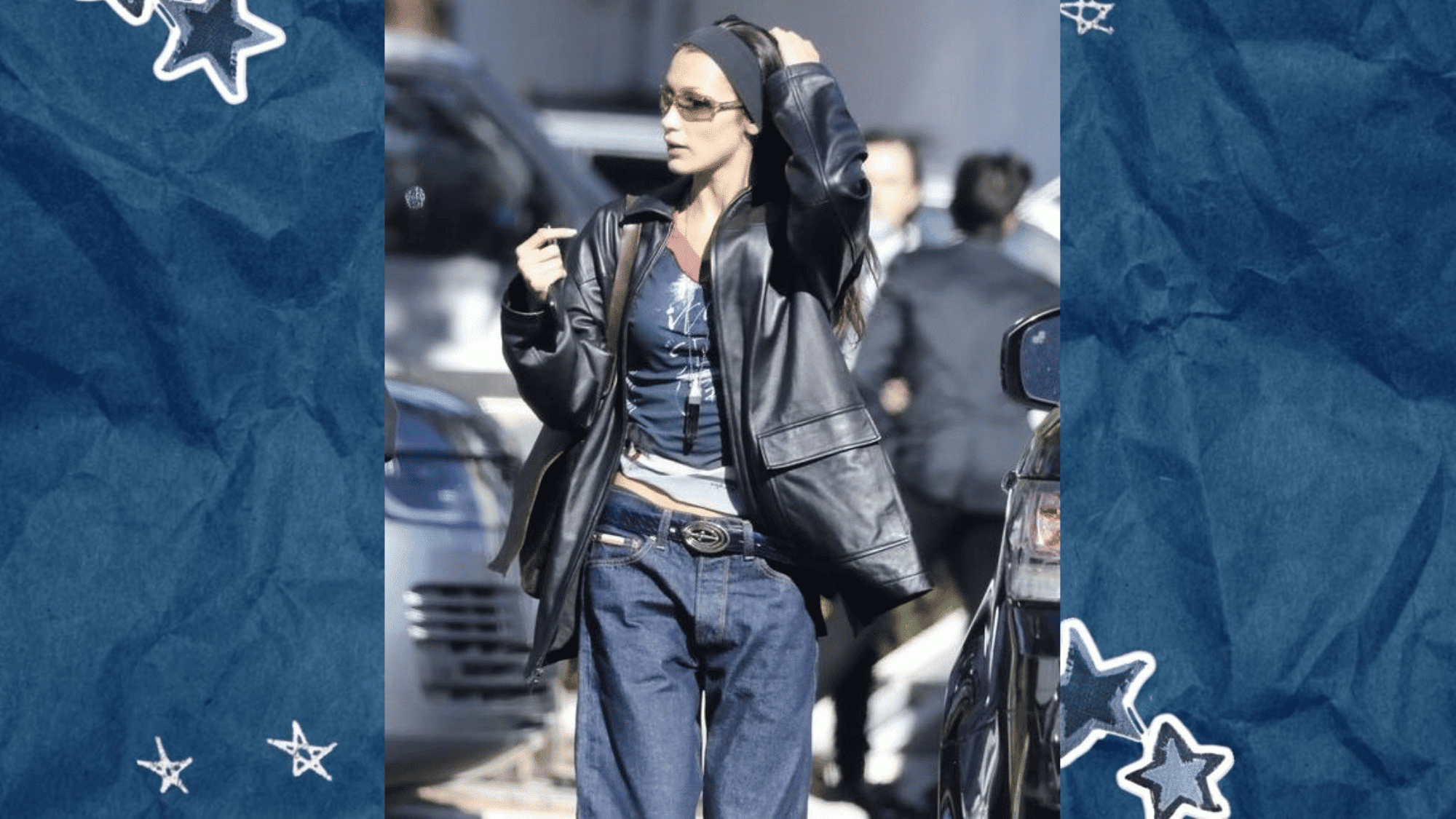 bella hadid wearing an oversized black leather jacket graphic tee baggy blue jeans and sunglasses for a relaxed downtown street style look