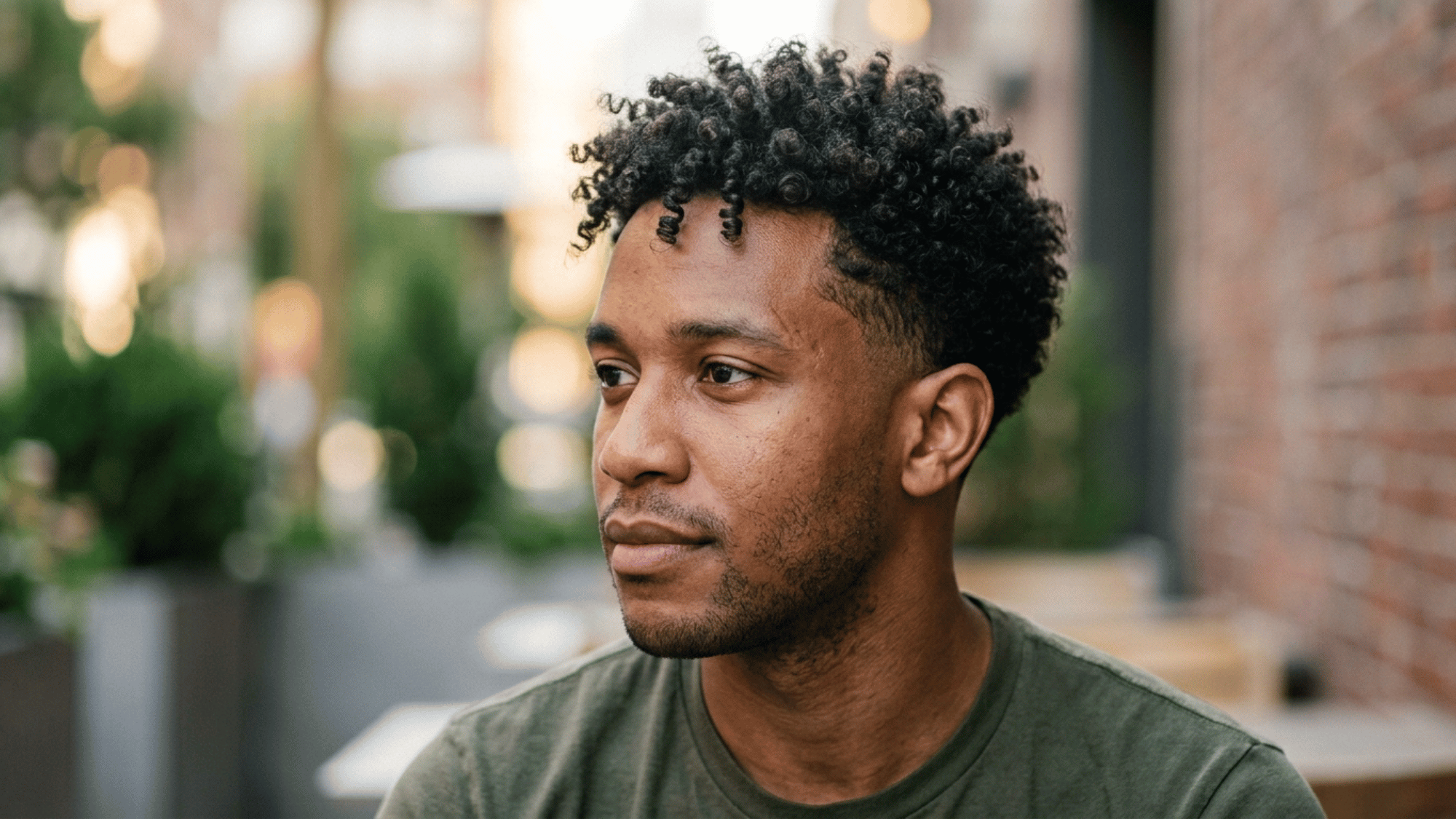 man with short curls and clean tapered sides