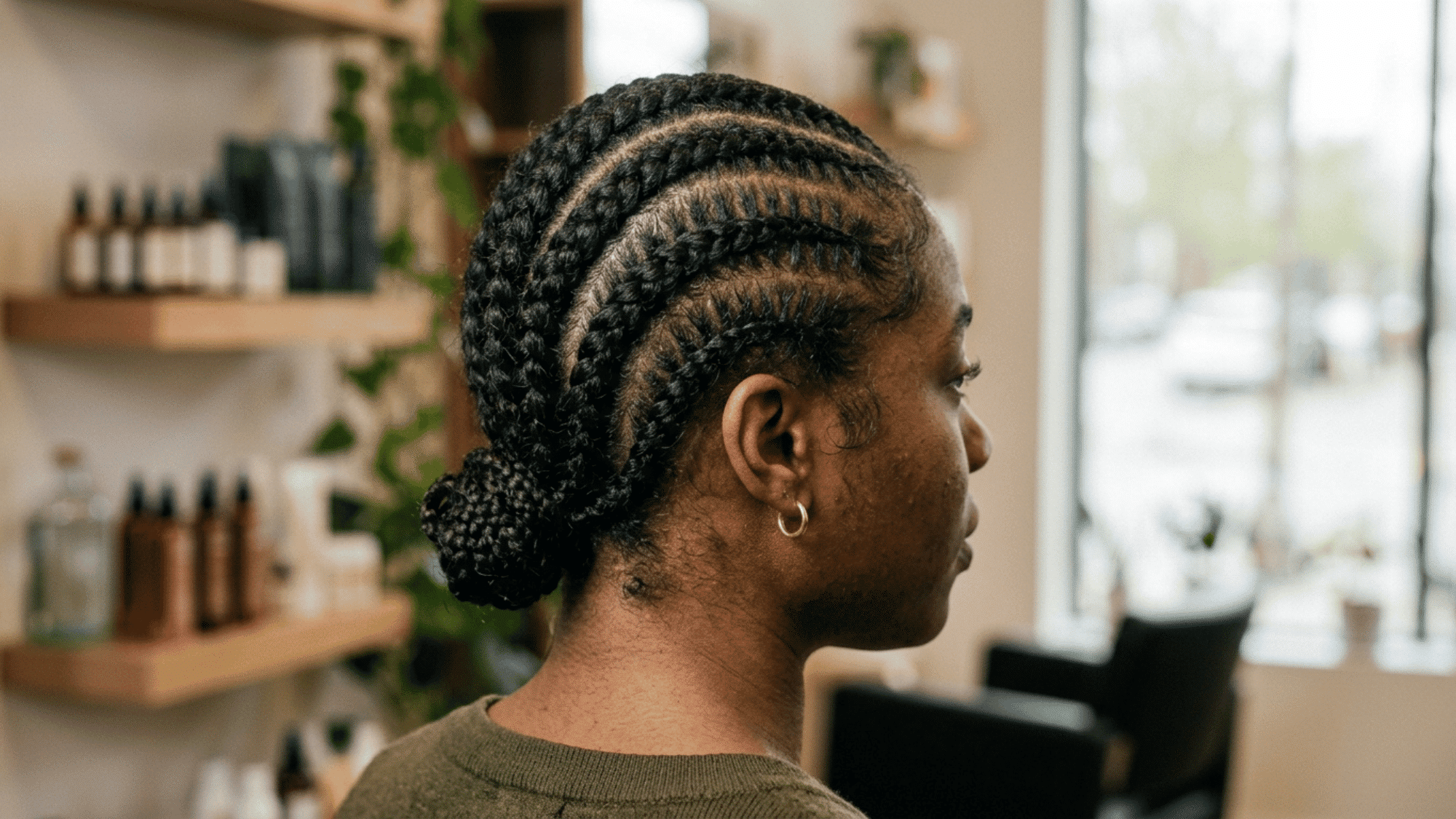 side view of woman wearing curved cornrow braids