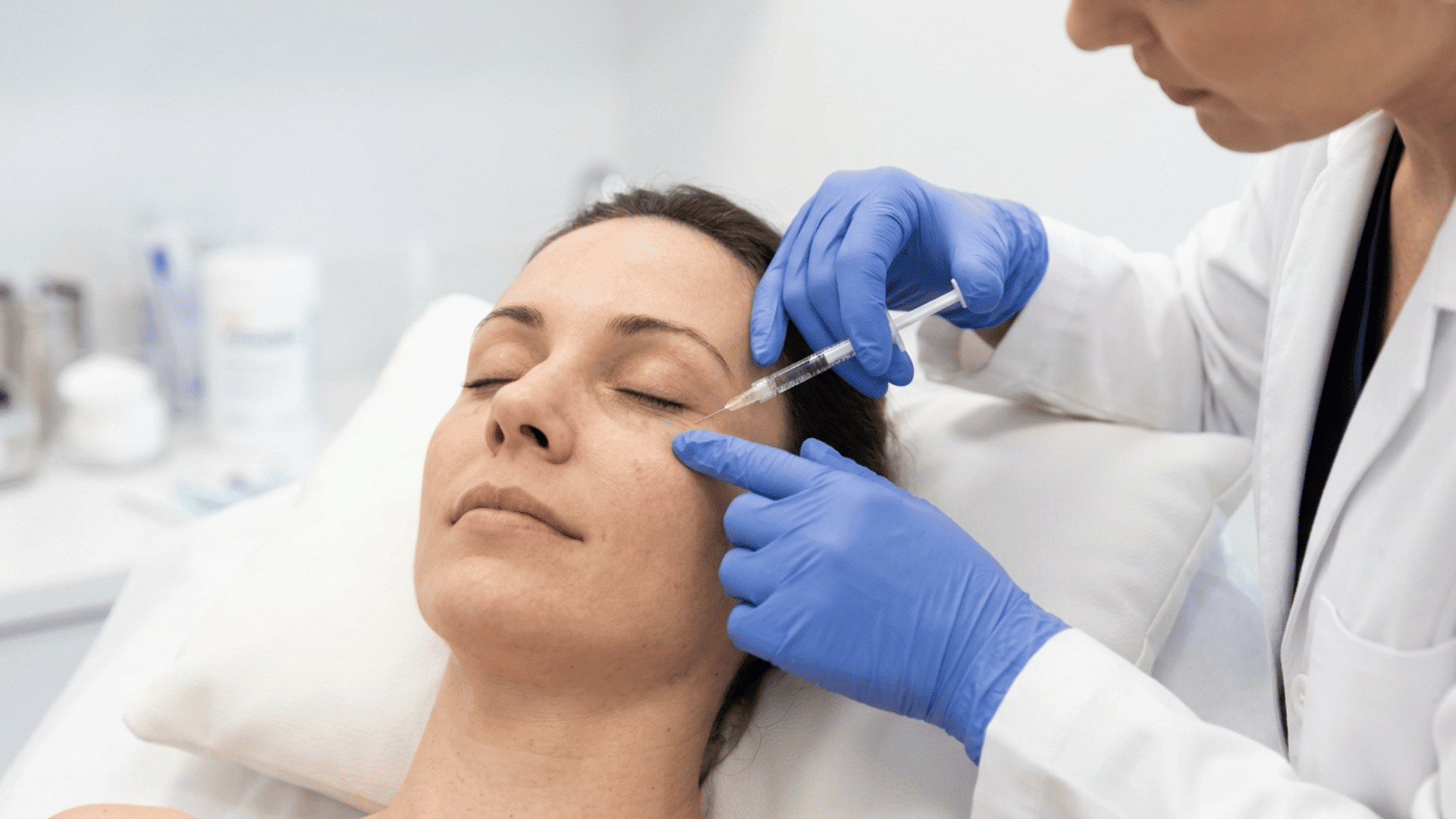 dermatologist injecting under-eye filler into a patient's lower eyelid area