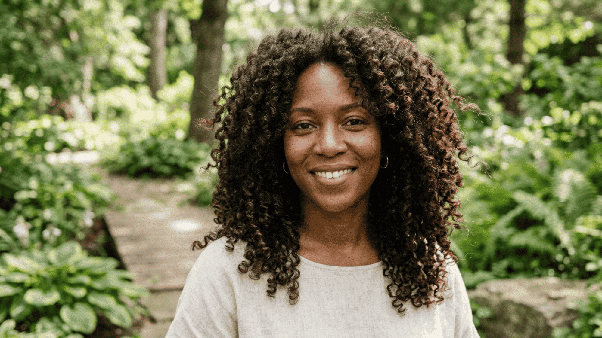 woman outdoors with long layered curls and balanced volume