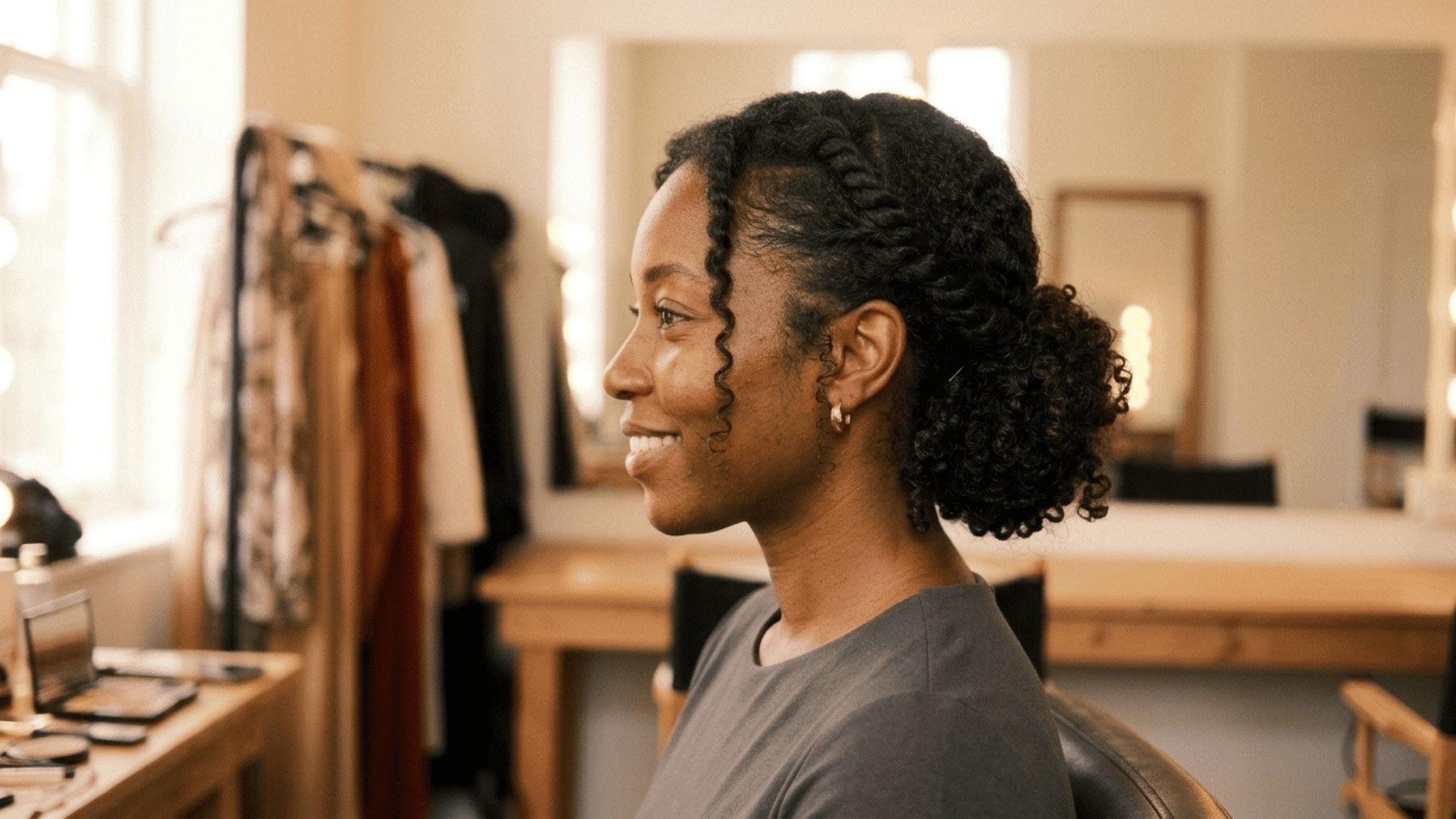 side view of woman wearing low curly updo