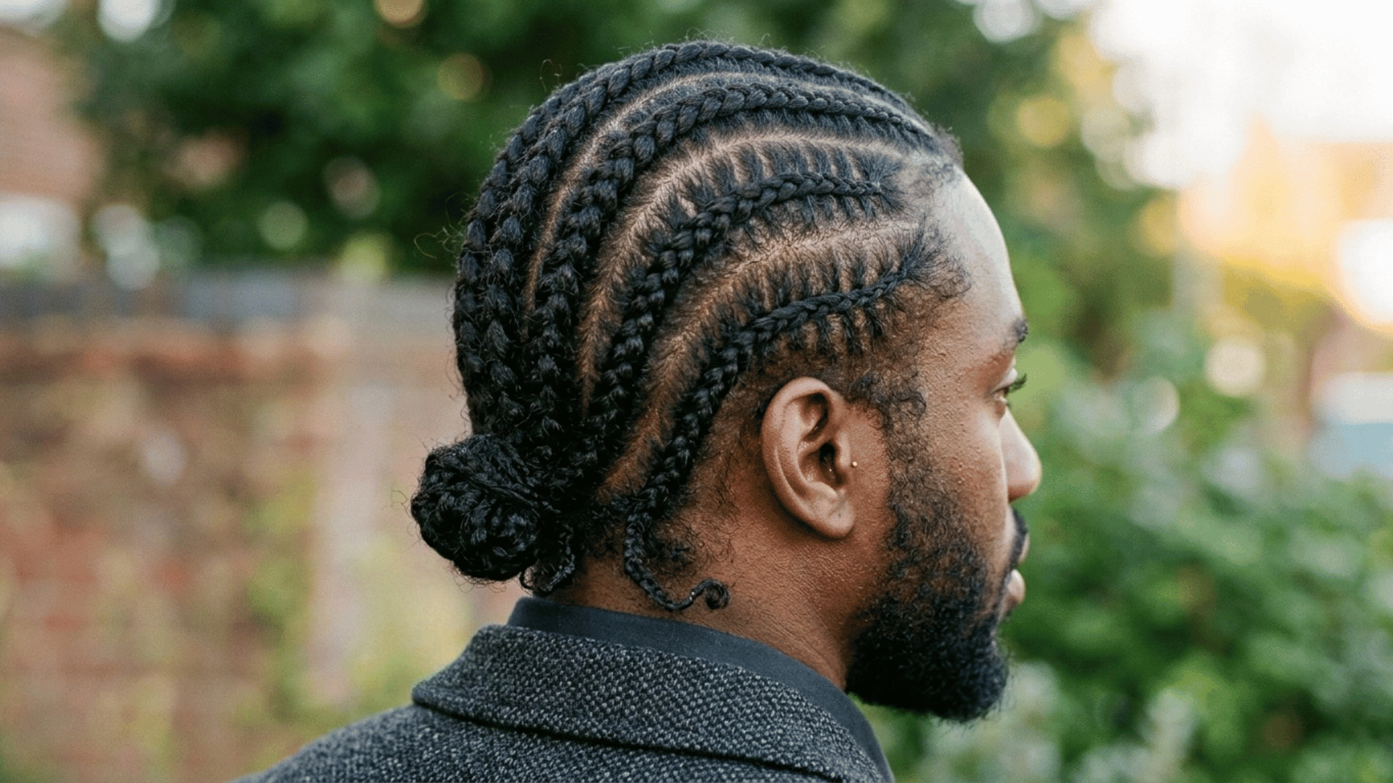 rear view of man wearing curved cornrow braids