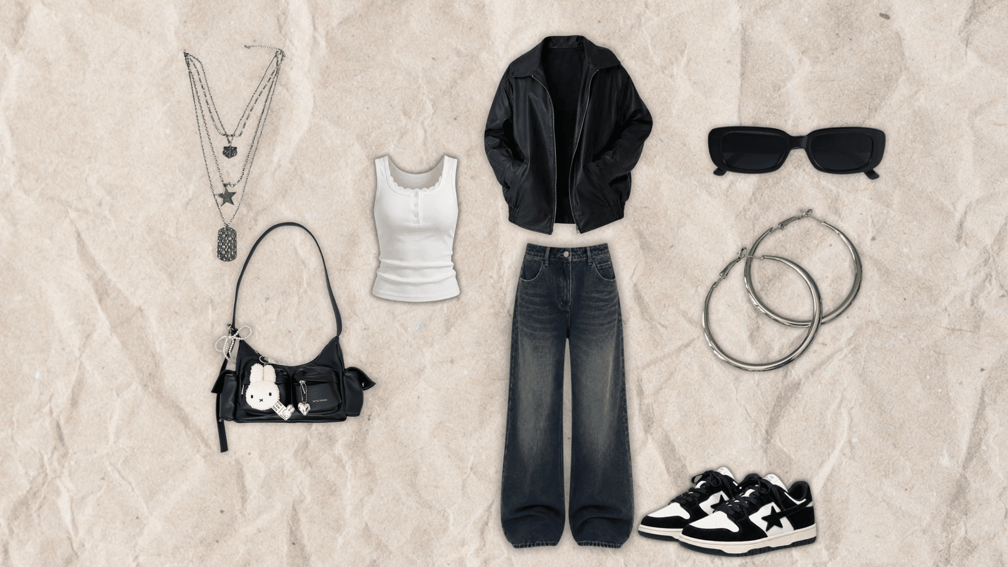 oversized black leather jacket layered over a white tank with baggy dark jeans black sneakers silver jewelry and shoulder bag