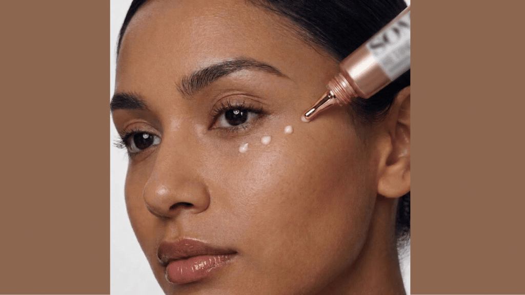close up of dropper applying retinol serum drops under the eye