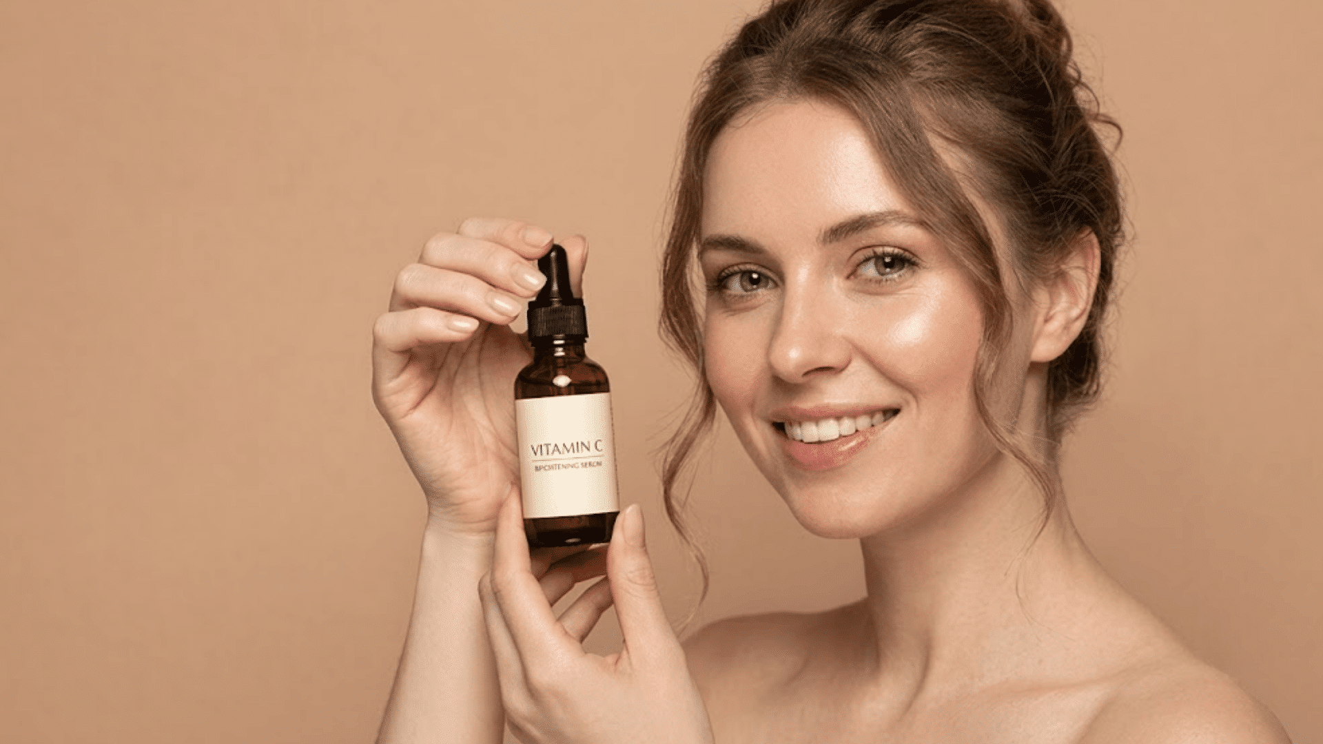 woman holding vitamin c serum bottle for brightening skincare routine and dark spot care