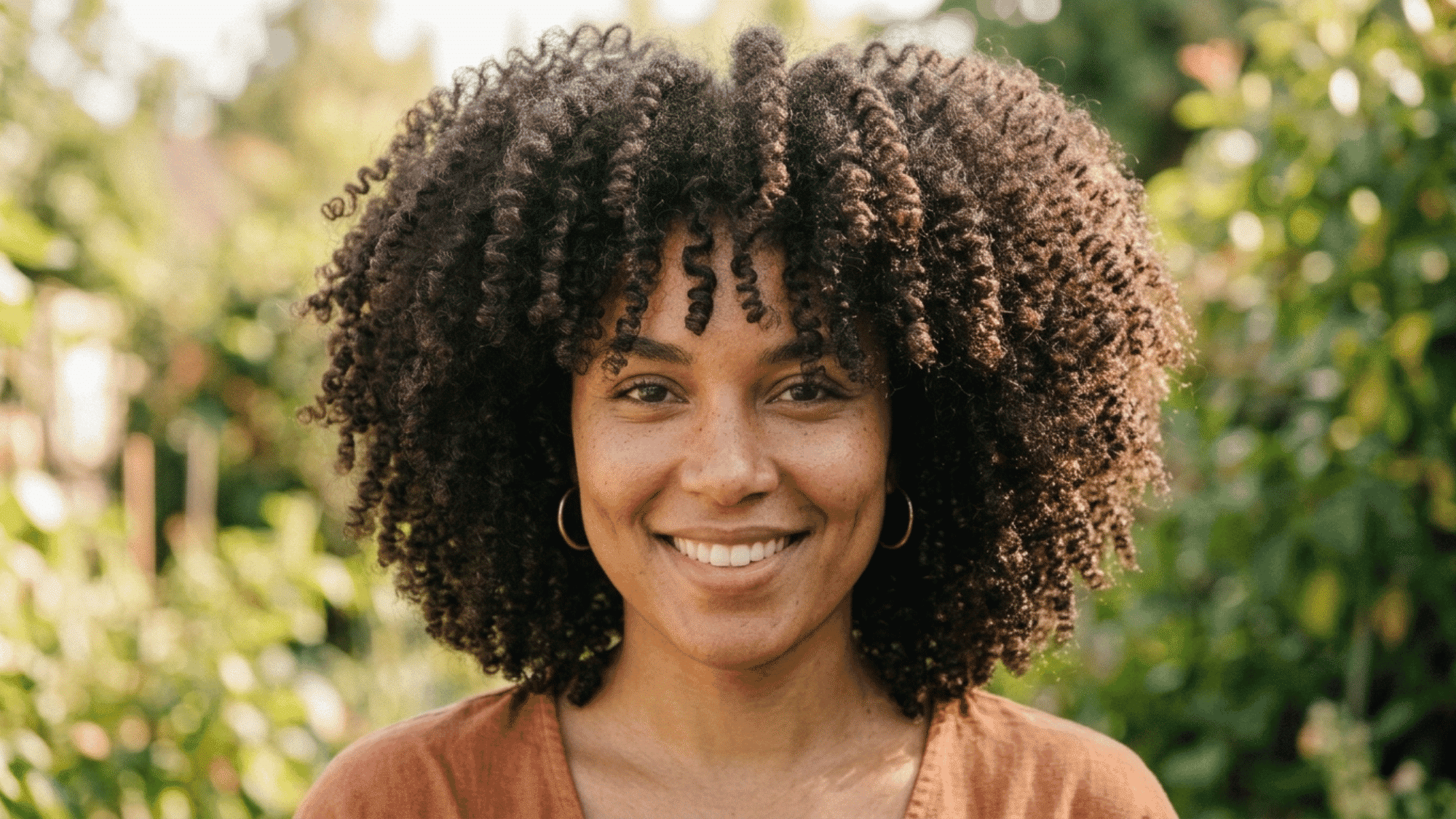 close-up of woman with tight, voluminous 3C curly hair pattern